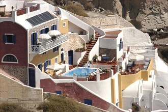 GREECE, Cyclades, Santorini, Hillside building with terrace and swimming pool