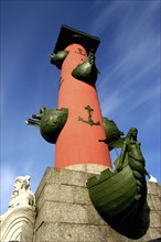 RUSSIA, St Petersburg, Angled view of Rostral Column with anchor motif and figureheads on boat bows