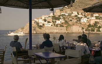 GREECE, Saronic Islands, Hydra, A cafe overlooking the entrance to the port in Hydra Town.