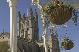ENGLAND, Bath, View of the east face of Bath Abbey seen from under veranda with hanging baskets
