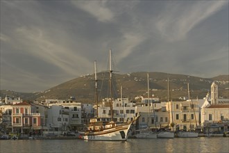 GREECE, Cyclades, Tinos, Yachts moored along the waterfront at Hora aka Tinos Town