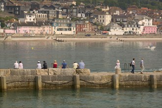 ENGLAND, Dorset, Lyme Regis, View of the town across the harbour from The Cobb.