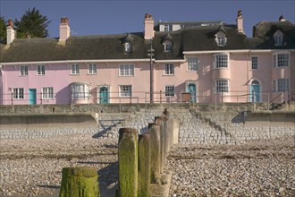 ENGLAND, Dorset, Lyme Regis, View of old fishermens cottages along the waterfront from the beach