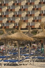 SPAIN, Balearic Islands, Majorca , Sun loungers and parasols on the beach at Palma Nova.