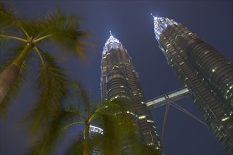 MALAYSIA, Kuala Lumpur, Angled view looking up at the Petronas Towers at dusk.