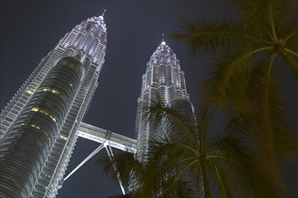 MALAYSIA, Kuala Lumpur, Angled view looking up at the Petronas Towers at dusk.