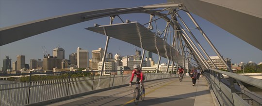 AUSTRALIA, Queensland, Brisbane, Cyclists and pedestrians crossing the Goodwill Bridge.
