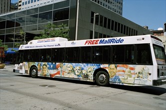 USA, Colorado, Denver, City bus beside building