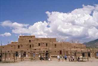 USA, Colorado, Taos Pueblo, Inhabited historical dwellings with tourists outside
