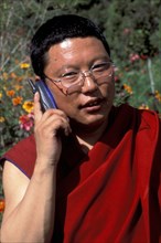 COMMUNICATIONS, Mobile Phones, Buddhist monk talking on a mobile phone