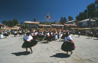 PERU, Puno, Lake Titicaca, Taquile Island. Dancers in local costume take part in Island Festival