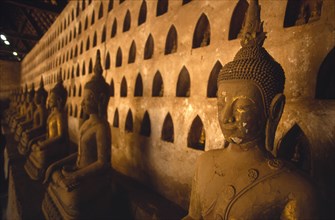 LAOS, Vientiane, Wat Si Saket.  Detail of Buddha figures in temple interior.