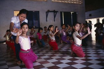 CAMBODIA, Phnom Penh, Teacher with ballet students at the Royal University of Fine Arts.