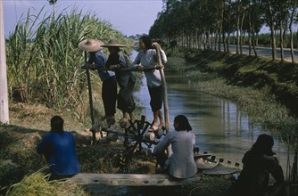 CHINA, Water, Women on treadmill lifting water for irrigation of crops.  This type of treadmill is