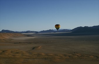 NAMIBIA, Namib Rand Reserve, Hot air balloon above Camp Mwisho.