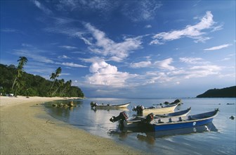 MALAYSIA, Terengganu, Perhentian Besar, Boats moored along quiet sandy beach on larger of the two