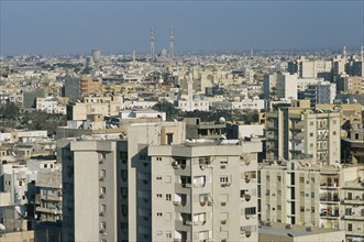 LIBYA, Tripoli, Cityscape view over housing and urban architecture toward distant Mosque
