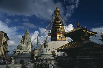 NEPAL,  Kathmandu Valley, Swayambhunath, Buddhist stupa hung with prayer flags in temple complex.