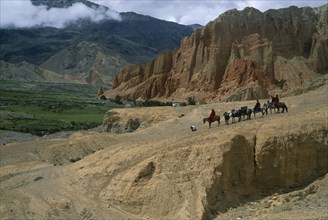 NEPAL, Mustang, Drakhmar , High ranking Tibetan lama and attending monks leaving Drakhmar on
