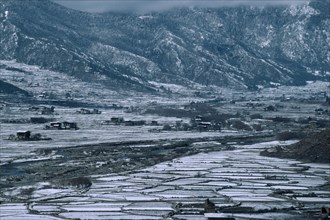 BHUTAN, Paro Valley, Paro, Agricultural landscape in winter snow.