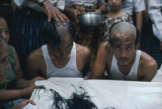 MYANMAR, Yangon, Ritual head shaving of initiate monks.