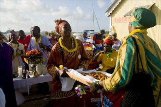WEST INDIES, St Vincent & The Grenadines, Union Island, Women handing out food amongst the Baptist