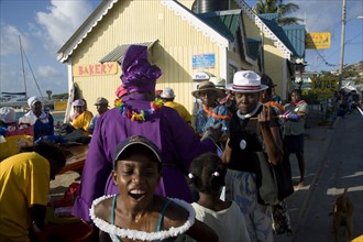 WEST INDIES, St Vincent & The Grenadines, Union Island, Woman giving blessing with Holy Water