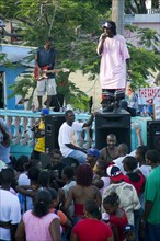 WEST INDIES, St Vincent & The Grenadines, Union Island, Singer and guitarist with sound system at