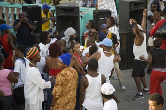 WEST INDIES, St Vincent & The Grenadines, Union Island, People dancing beside sound system at