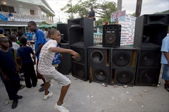 WEST INDIES, St Vincent & The Grenadines, Union Island, Boy dancing beside sound system at