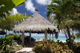 WEST INDIES, St Vincent & The Grenadines, Canouan, Palapa thatched entrance from hotel jetty at