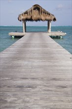 WEST INDIES, St Vincent & The Grenadines, Canouan, The jetty on Jambu Beach at Raffles Resort