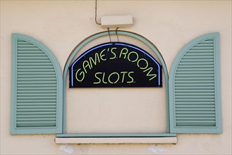WEST INDIES, Barbados, St James, Gambling rooms neon sign in faked window promoting Slots in