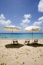 WEST INDIES, Barbados, St Peter, Sun shade umbrellas and chairs on Gibbes Beach with people