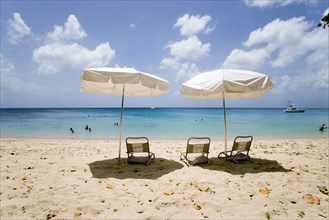WEST INDIES, Barbados, St Peter, Sun shade umbrellas and chairs on Gibbes Beach with people