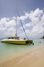 WEST INDIES, Barbados, St Peter, Catamaran with tourists moored on Gibbes Beach