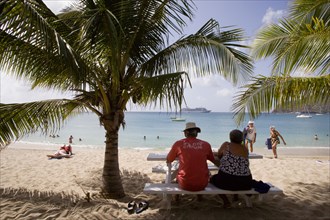 WEST INDIES, St Vincent & The Grenadines, Bequia, Tourists on beach at Lower Bay with cruise ship