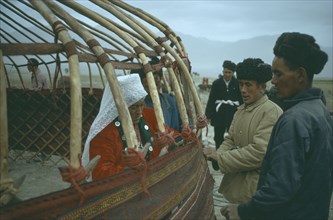AFGHANISTAN, People, Nomadic Kirghiz men and women building frame for traditional ger.