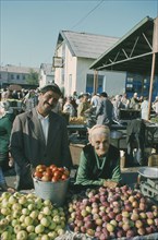 KIRGHIZSTAN, Frunze, Elderly stallholders selling fruit at market.