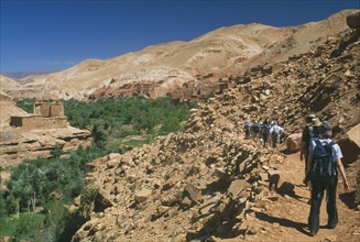 MOROCCO, High Atlas Mountains, General, "Tourist group walking along narrow, rocky path towards