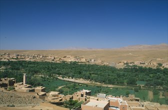 MOROCCO, Tinghir, Town buildings overlooking agricultural land and oasis.