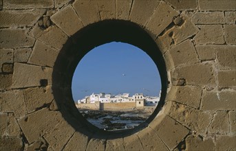 MOROCCO, Essaouira, Fortified coastal town framed in circular opening in wall.