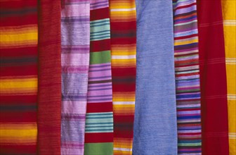 MOROCCO, Essaouira, Detail of colourful striped textiles.