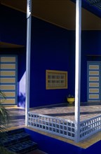 MOROCCO, Marrakesh, The Jardin Majorelle owned by Yves St Laurent.  Corner of balcony with walls