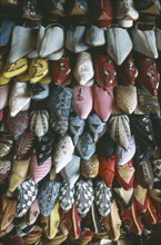 MOROCCO, Fes, Display of embroidered and decorated leather slippers or babouches.