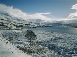 SCOTLAND, Highland, Loch Assynt, View south east across Loch in March snowfall.