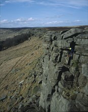 ENGLAND, Derbyshire, Stanage Edge, View northwards along edgeof gritstone craggs with rock climbers