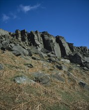 ENGLAND, Derbyshire, Stanage Edge, Gritstone craggs with rock climbers.