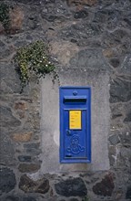 UNITED KINGDOM, Channel Islands, Guernsey, Traditional blue post box on wall.