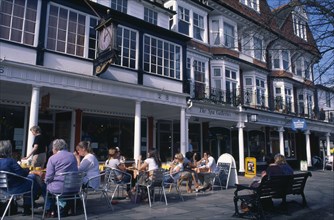 ENGLAND, Kent, Tunbridge Wells, The Pantiles. Cafe with outside seating and people sat at tables.